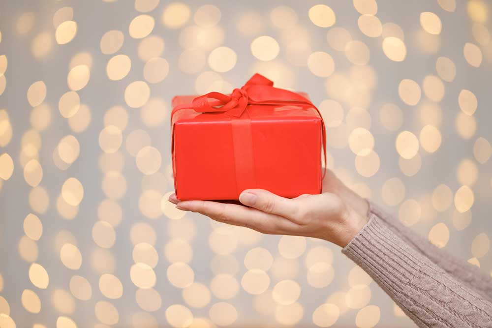 a-magical-glowing-present-box-being-holded-by-a-wo-2021-08-29-21-03-17-utc